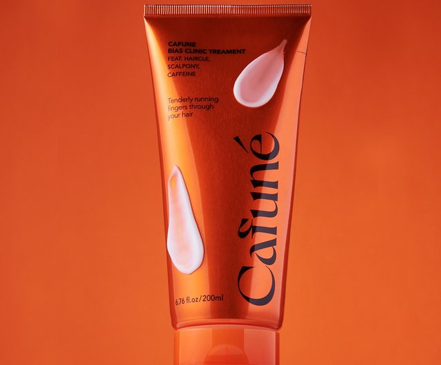 Tubo Cafuné Bias Clinic Treatment arancione con texture crema, trattamento riparatore capelli e cute con caffeina e attivi rinforzanti.