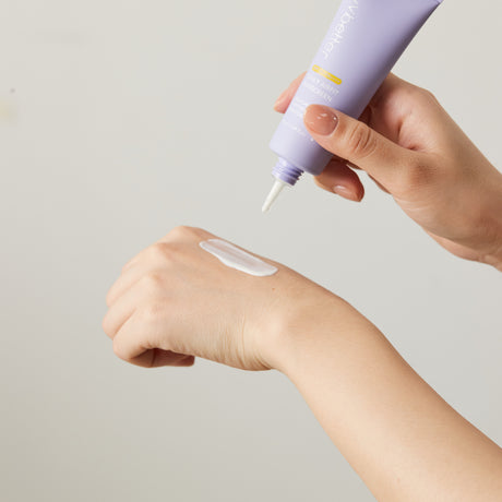 Una mano applica il vvbetter Daily Airfit Sunscreen SPF 50+ PA++++ sulla pelle dell’altra mano. La texture bianca del prodotto è visibile, suggerendo una consistenza cremosa e facilmente stendibile. L'immagine evidenzia la semplicità d’uso e la delicatezza sulla pelle.